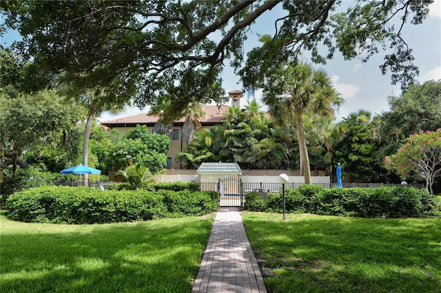 surrounding community featuring a lawn and fence