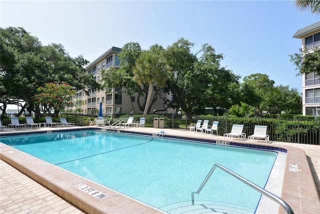 pool featuring a patio area and fence