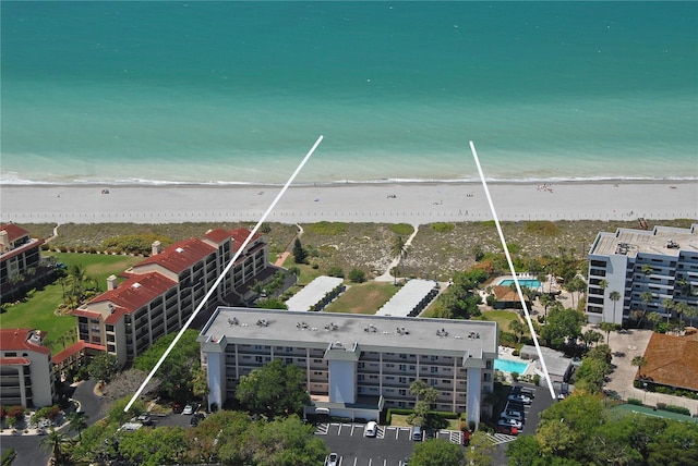 birds eye view of property with a view of the beach and a water view