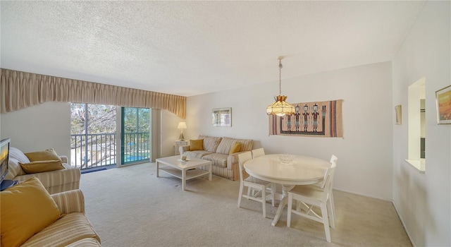 living room featuring light colored carpet, a chandelier, and a textured ceiling
