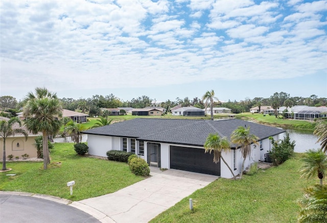 single story home featuring a residential view, stucco siding, a front yard, and a garage