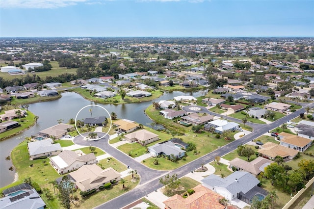 bird's eye view with a residential view and a water view