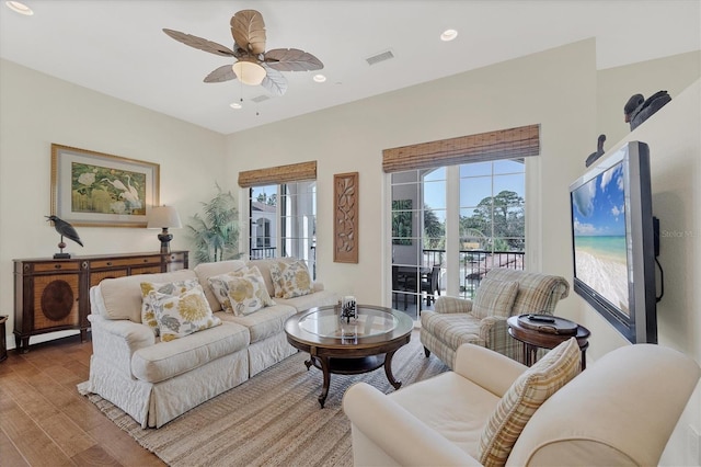 living area featuring visible vents, recessed lighting, ceiling fan, and wood finished floors