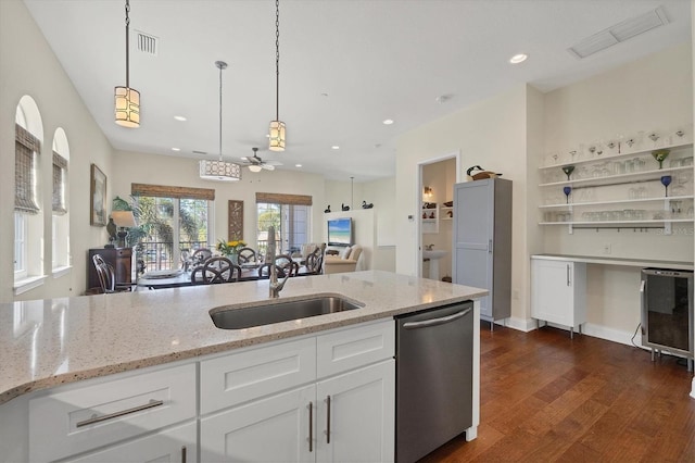 kitchen featuring pendant lighting, a sink, white cabinetry, dishwasher, and dark wood-style flooring