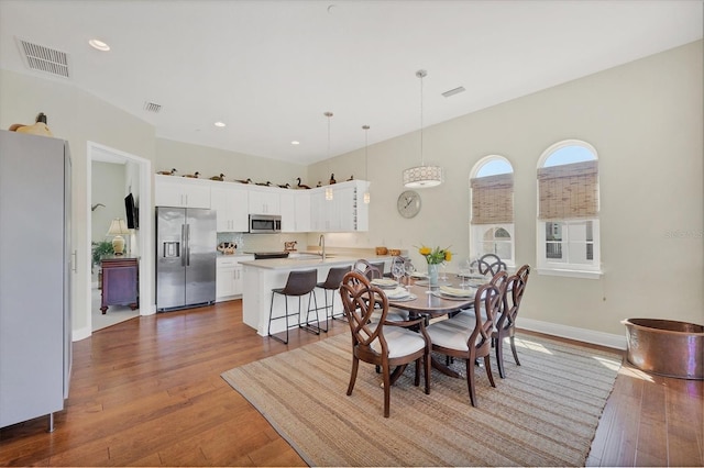 dining area featuring visible vents and hardwood / wood-style floors