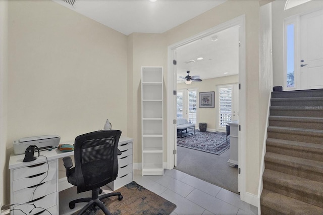 carpeted office with tile patterned floors and baseboards