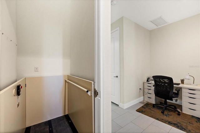 tiled home office with visible vents and baseboards