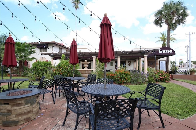 view of patio / terrace featuring outdoor dining area and a fire pit