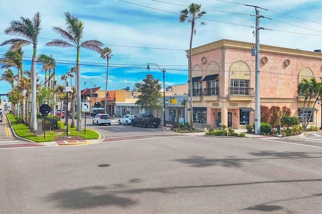 view of street with sidewalks, curbs, and street lights