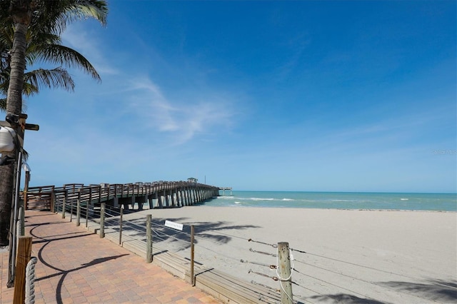 view of water feature featuring a pier and a beach view