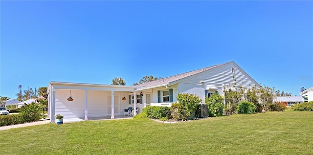 rear view of house featuring a yard