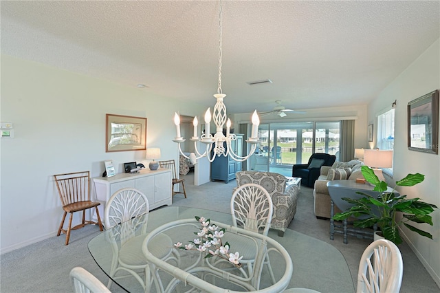 dining space featuring baseboards, light colored carpet, visible vents, and a textured ceiling