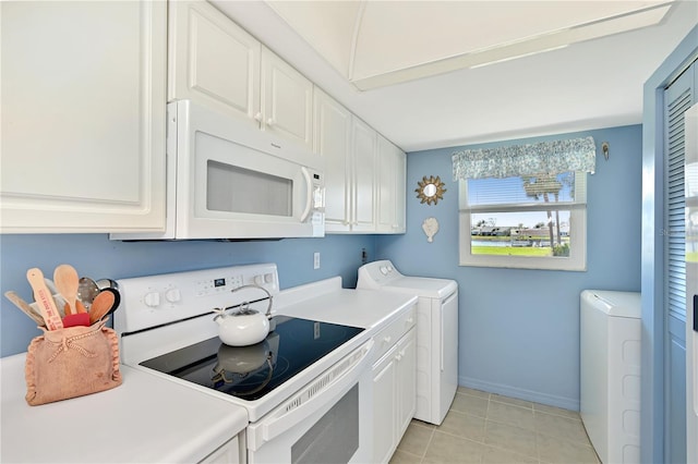 kitchen with white appliances, white cabinetry, light tile patterned flooring, light countertops, and washer and dryer