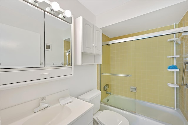 full bath with combined bath / shower with glass door, toilet, and vanity