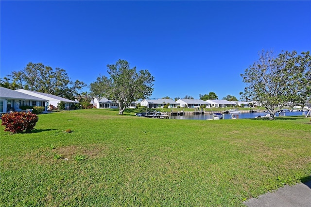 view of yard featuring a residential view and a water view