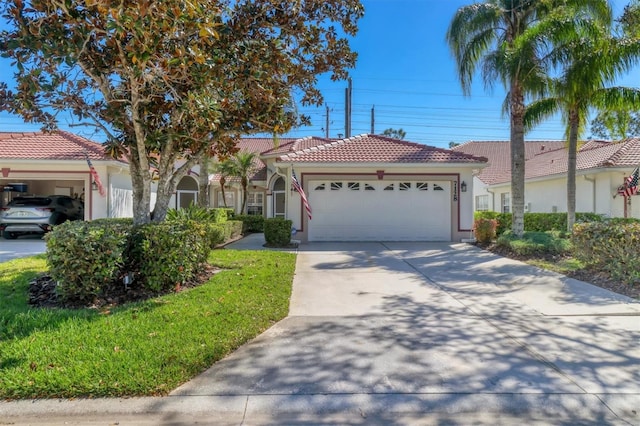 view of front facade featuring a tile roof, an attached garage, driveway, and stucco siding