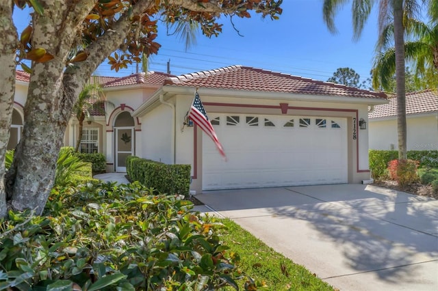 mediterranean / spanish-style home featuring stucco siding, a tiled roof, driveway, and a garage