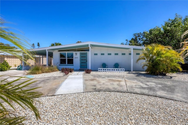 mid-century inspired home with driveway