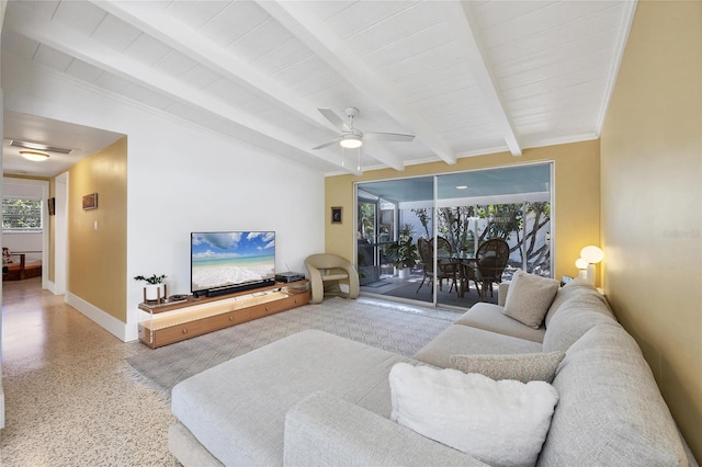 living area featuring beam ceiling, ceiling fan, speckled floor, and baseboards