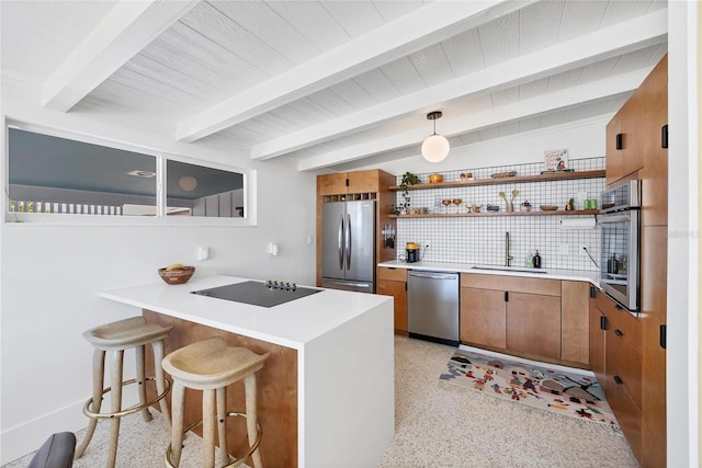 kitchen with open shelves, light speckled floor, appliances with stainless steel finishes, and a sink