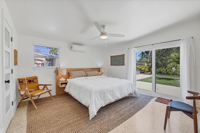 bedroom featuring light speckled floor, an AC wall unit, a ceiling fan, and access to outside