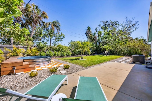 view of property's community with a yard, a patio, a hot tub, and fence