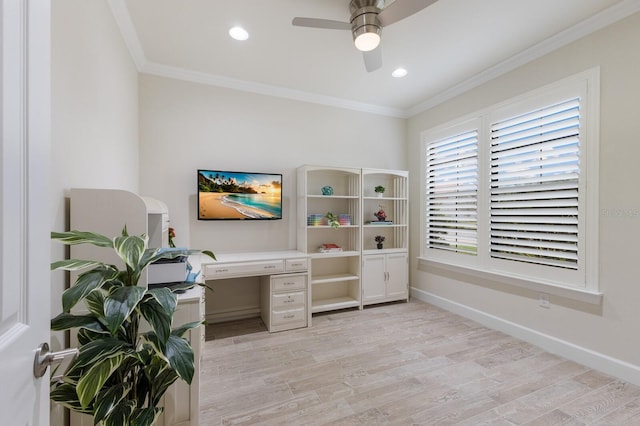 home office featuring a ceiling fan, crown molding, light wood-style floors, and baseboards