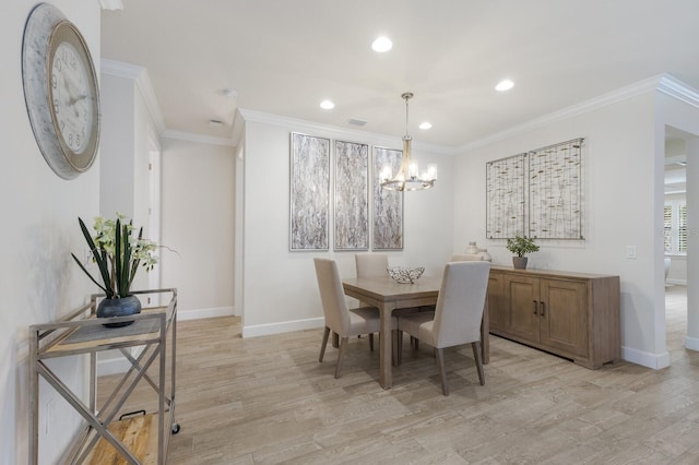 dining area with an inviting chandelier, light wood-type flooring, and ornamental molding