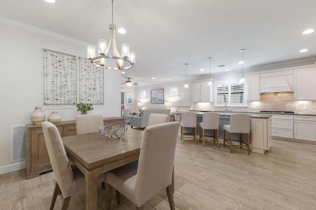 dining space with visible vents, ceiling fan, light wood-type flooring, ornamental molding, and recessed lighting