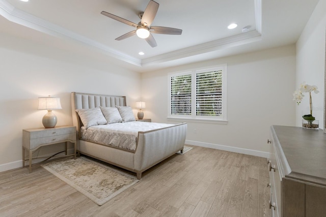 bedroom with recessed lighting, baseboards, a raised ceiling, and light wood finished floors