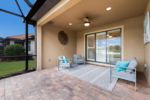 view of patio / terrace with ceiling fan and a lanai