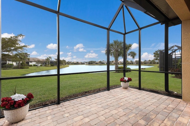 unfurnished sunroom featuring a water view