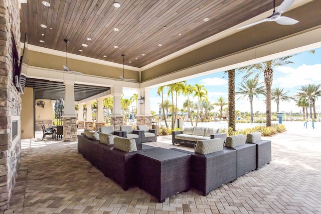 exterior space featuring an outdoor hangout area and a ceiling fan