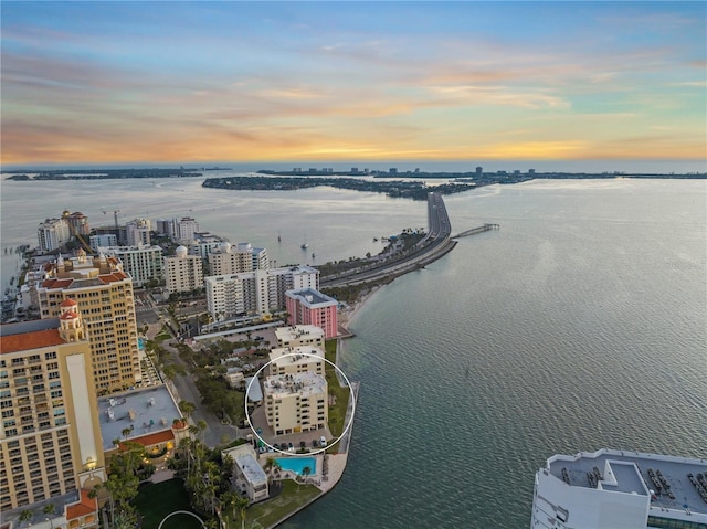 birds eye view of property featuring a view of city and a water view