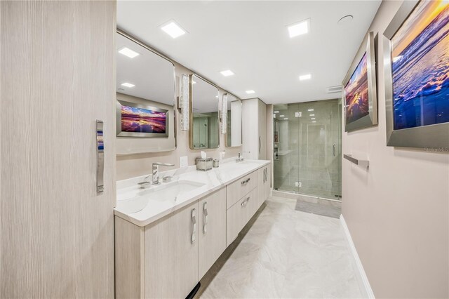 full bathroom featuring a sink, baseboards, a stall shower, and double vanity