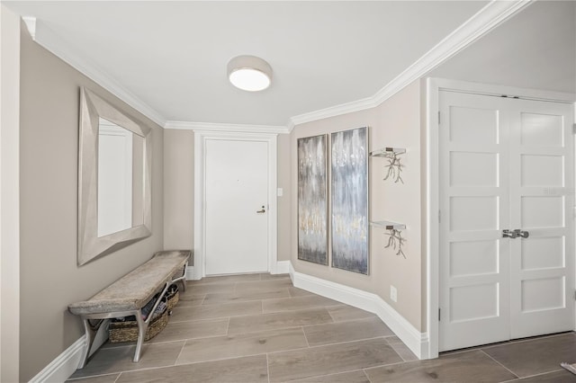 interior space with crown molding, baseboards, and wood tiled floor