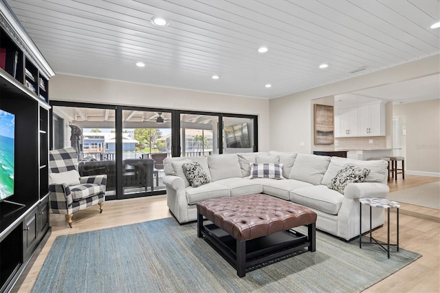 living area with baseboards, recessed lighting, wood ceiling, and light wood-style floors