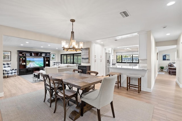 dining space with an inviting chandelier, recessed lighting, visible vents, and light wood finished floors