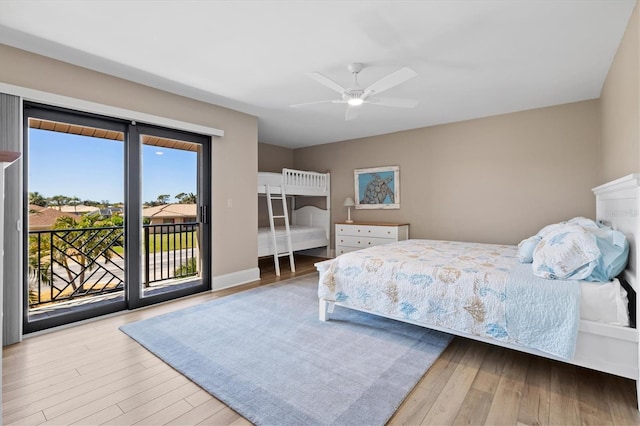 bedroom with baseboards, wood finished floors, a ceiling fan, and access to outside