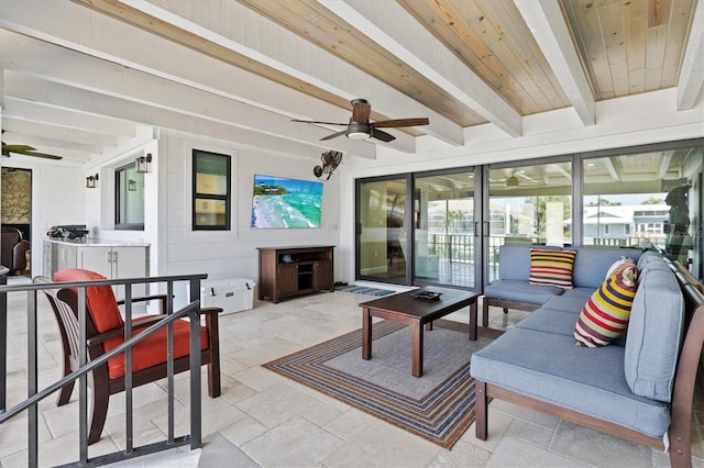 exterior space with beam ceiling, stone tile floors, wooden ceiling, and ceiling fan