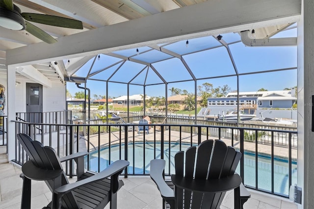 view of patio / terrace featuring a lanai, a residential view, a fenced in pool, and a ceiling fan