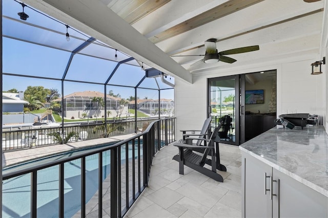 view of patio featuring a fenced in pool, ceiling fan, a water view, a residential view, and glass enclosure