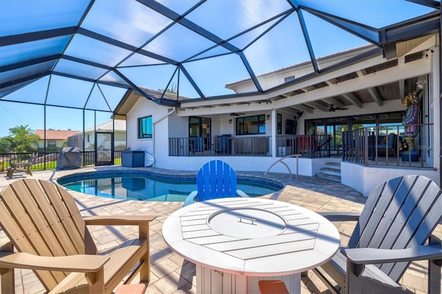 outdoor pool featuring a lanai, ceiling fan, and a patio