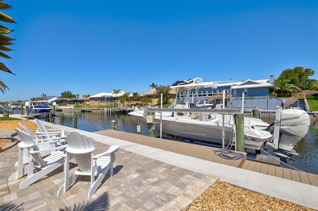 view of dock featuring a residential view, a water view, and boat lift