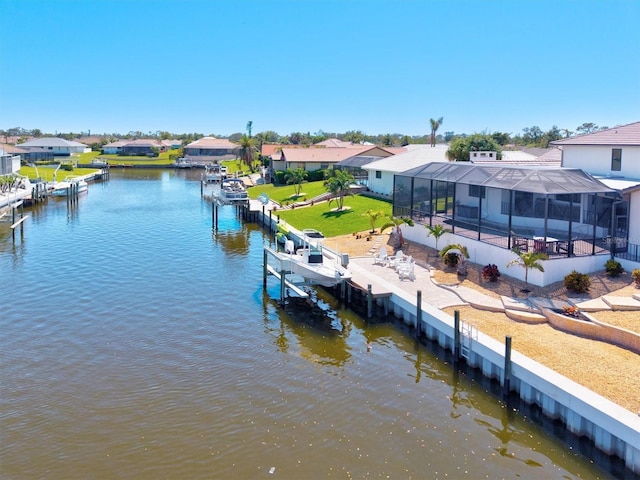 dock area with a lanai, a residential view, a yard, and a water view