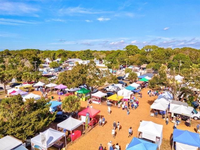 bird's eye view with a wooded view