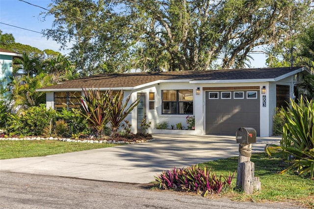 ranch-style home featuring stucco siding, driveway, and an attached garage