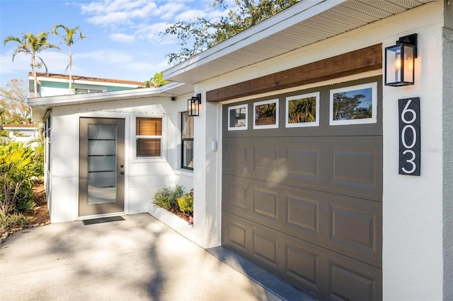 doorway to property featuring a garage