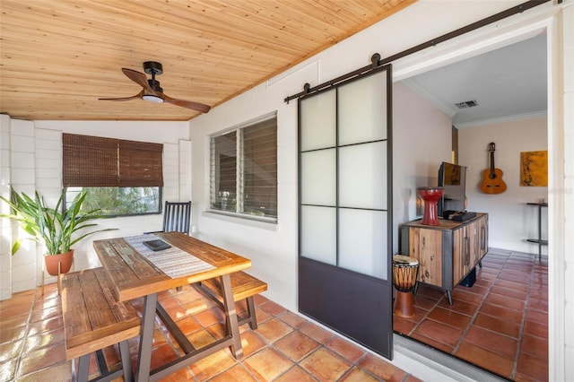 sunroom featuring ceiling fan, a barn door, visible vents, and wooden ceiling