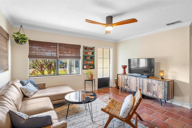 tiled living area with ceiling fan, baseboards, visible vents, and ornamental molding